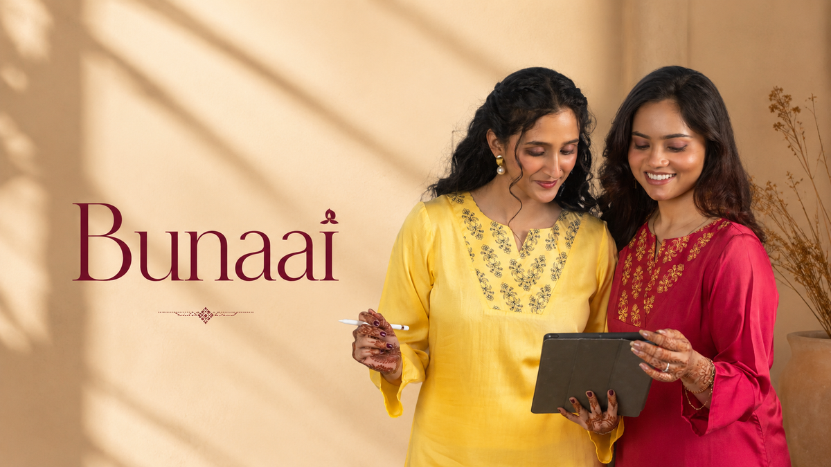 Two women standing indoors wearing traditional Indian salwar kameez, one in yellow and one in pink, holding a tablet. The word 'Bunaai' is displayed on the left against a warm beige background with soft shadow patterns.